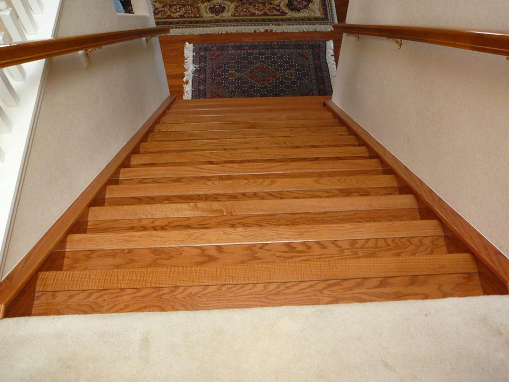 Formerly carpeted stairs. Replace carpet with Bruce hardwood flooring , Treads, risers, skirts and skirt topper. Stained and varnished skirt topper to match factory finish. I also did the floors in the living room, den & hallway.